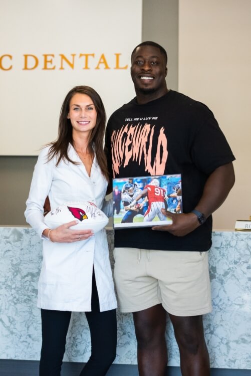 Dr. Bri posing with Michael Dogbe after their teeth whitening treatment in Scottsdale, AZ