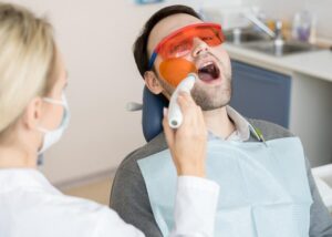 A doctor is providing laser gum treatment to a patient in Scottsdale, AZ