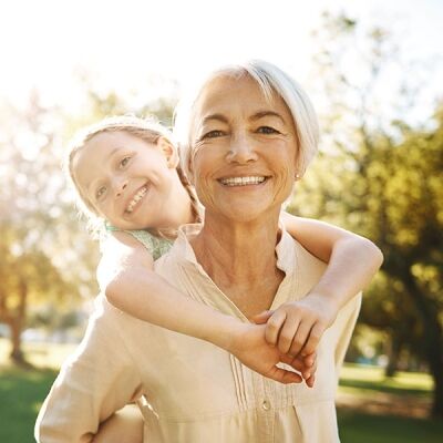 Happy grandmother and granddaughter smiling after dental implant treatment in Scottsdale