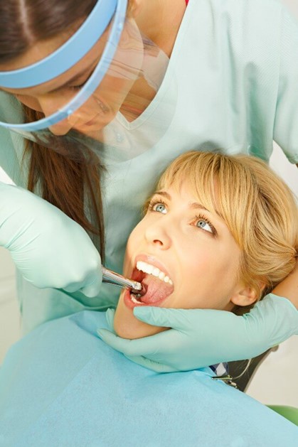 Women getting Her teeth Checked for extraction in AZ