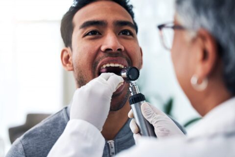 Dentist examines mans mouth in Scottsdale, AZ